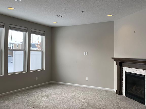 Living room with fireplace & recessed lighting