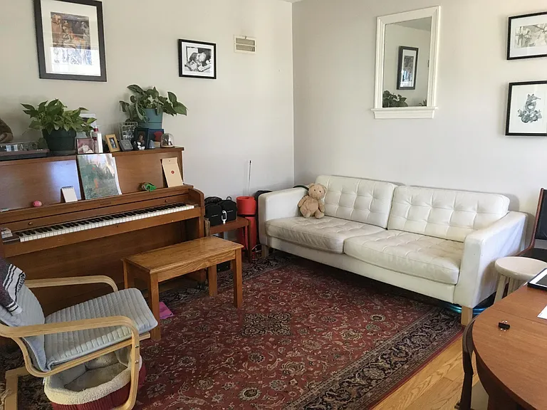 Living room with previous tenant's furniture looking from front door in.