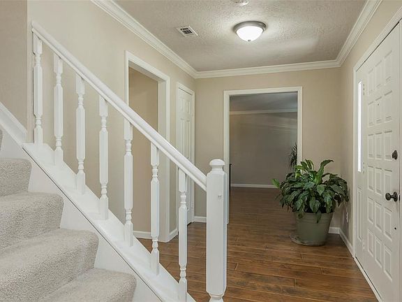 ...and to the front living room to the right! Notice all of the fresh interior paint, tons of crown molding and fresh, neutral carpet on the stairs.