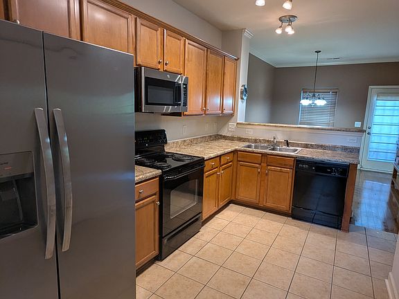Kitchen view facing back door that leads to outside patio