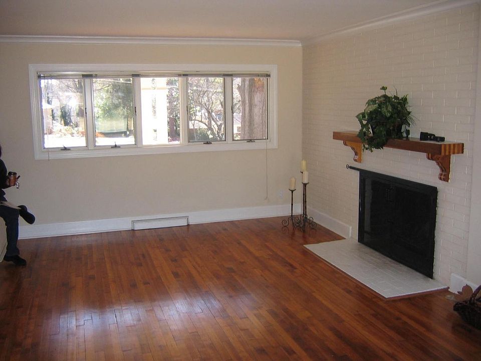 Living room spans with windows that look out to front yard t