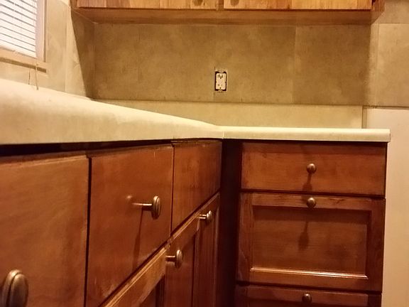 Kitchen showing backsplash of another 1 bed unit to give per