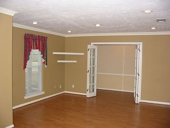 Large formal living room with gorgeous laminate flooring.