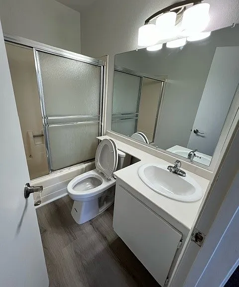 Upstairs full bath with new flooring, new toilets, and freshly painted