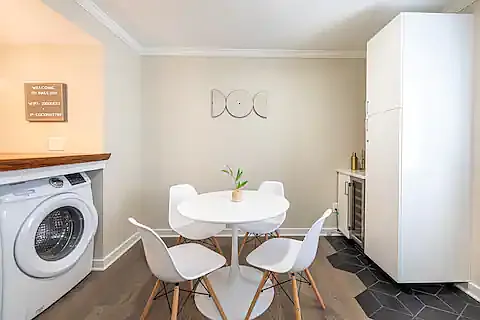 Dining table for four, wine fridge and storage unit.