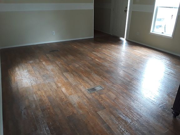 Huge living room w laminate flooring easy to clean .