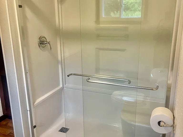 NEW SHOWER AND STOOL AND FLOORING IN BATHROON