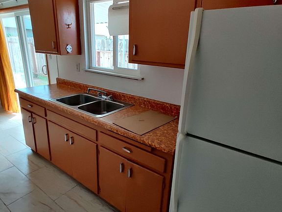 Kitchen (cabinets, sink, fridge)