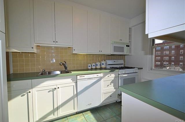 Updated kitchen with a dishwasher, microwave, range and refrigerator.  There are custom cabinets and plenty of counter space.