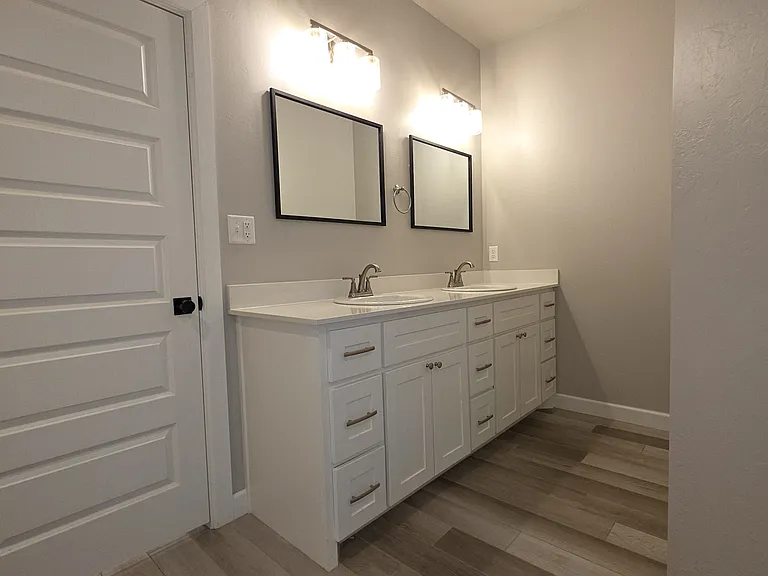 Master/Primary Bathroom double vanity with quartz countertops & double mirrors.