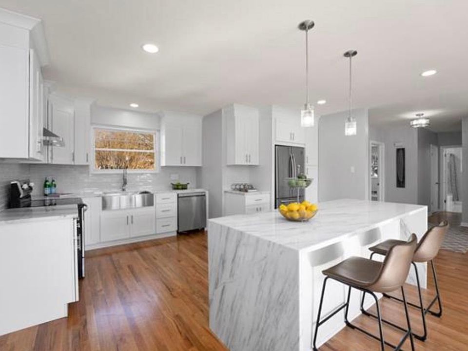 Absolutely gorgeous, renovated kitchen w/ island, marble counters, recessed lighting and gleaming hardwoods! Better yet- it opens up to the living room!