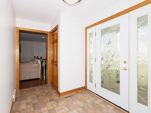 Gorgeous Entryway with the etched doors and nice size closet.  Home features solid six panel oak doors throughout.