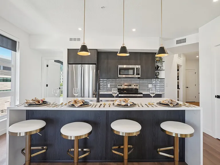 Liberty Duet Apartments, Salt Lake City, Utah; A modern kitchen with a bar area and a view of the city.
