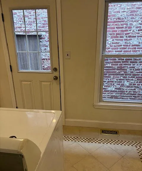 Back laundry room with exit to enclosed private patio.