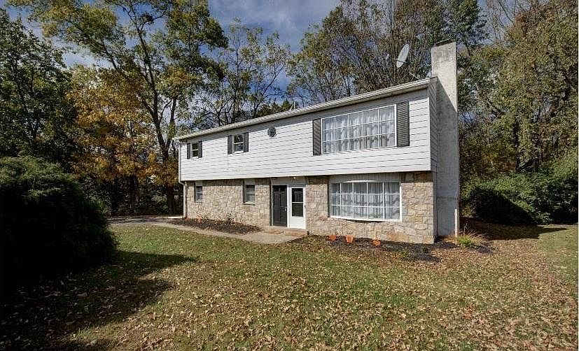 Beautiful stone exterior surrounded by foliage