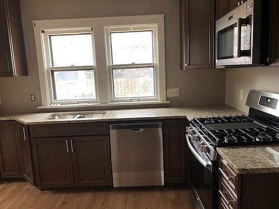 Granite kitchen with stainless steel appliances.