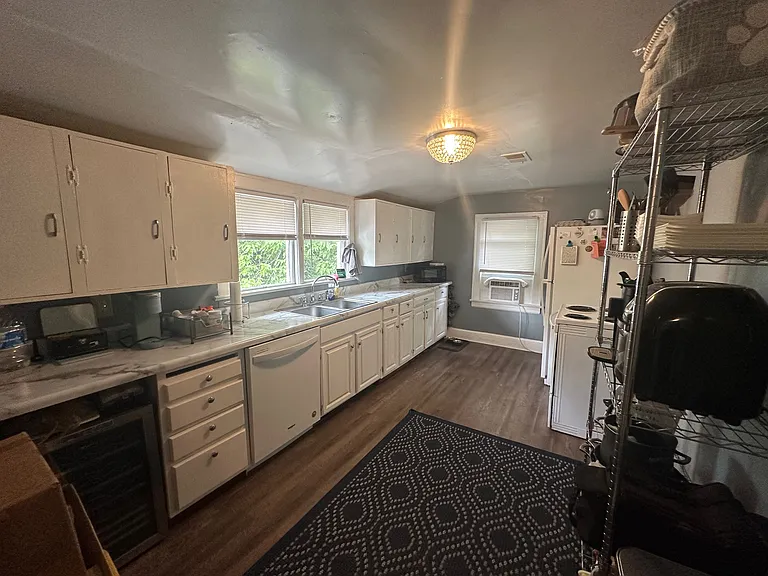 PRIOR TO NEW LUXURY VINYL TILE!
Previous Photo prior to new paint - Kitchen w/ Designer Crystal Lighting. Appliances include Refrigerator w/ Ice maker, Stove, Dishwasher and Wine Frig!
*Apartment has been painted w/ Sherwin Williams French Gray!*