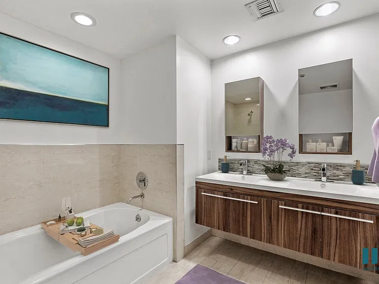 Bathroom with Bathtub and Double-Sink Vanity with Cabinet Storage