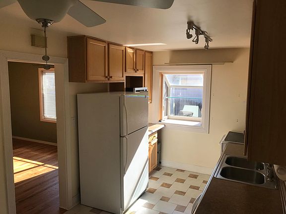 Kitchen with refrigerator, electric range/oven, microwave, and under-sink water filter system, which is great for Englewood's mineral-heavy water.