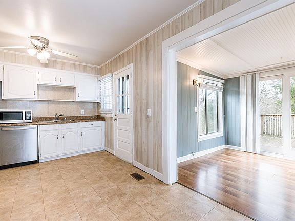 Kitchen/back sunroom area to enjoy a lot of Natural light while you are cooking or enjoying a meal