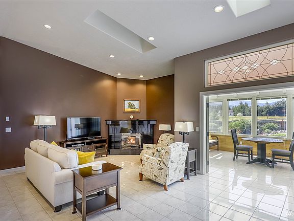 Sunroom to the right. Propane fireplace. Porcelain Tiled floors.>