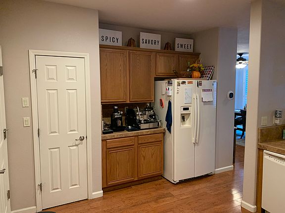 Kitchen area with door to walk in pantry, garage door to the left (outside of photo)