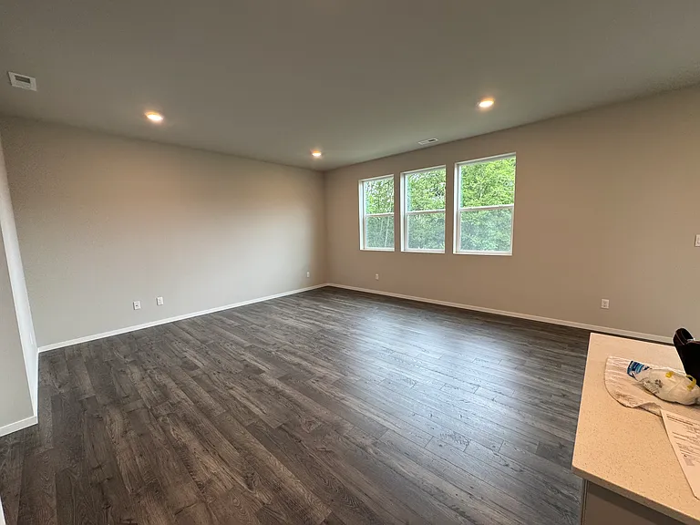 Main floor living room, off kitchen. Windows facing back yard.