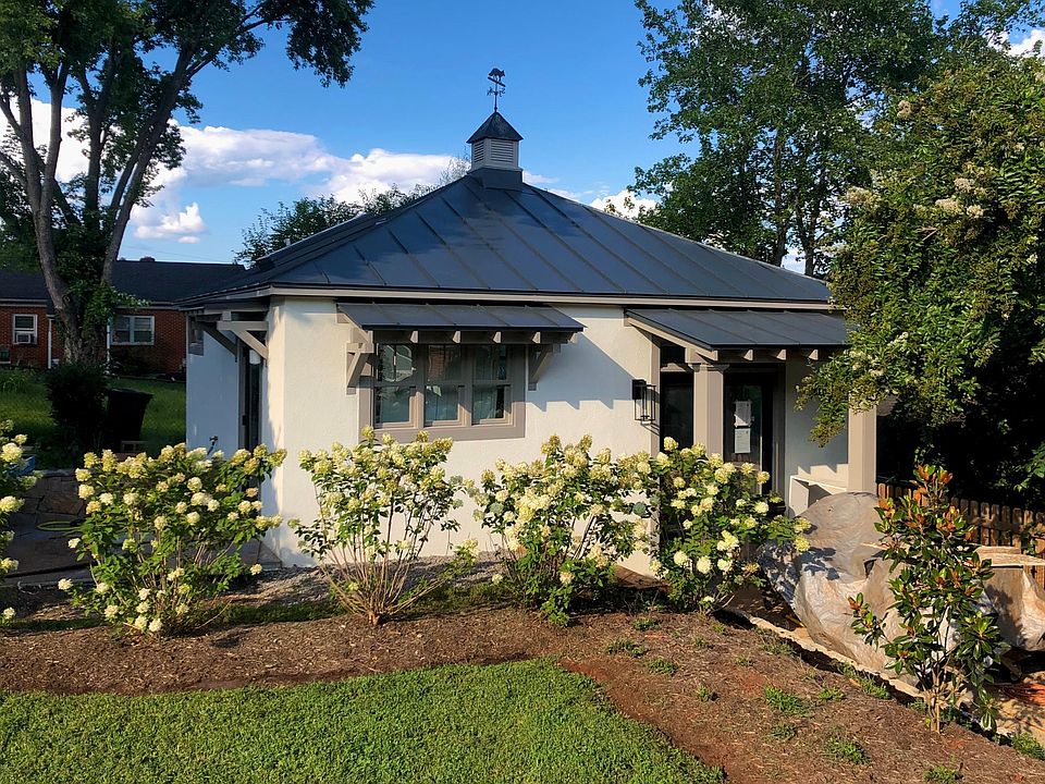 The cottage has french doors at the main entrance from the driveway/walkway. There''s a single door on the left leading to a small stone patio.