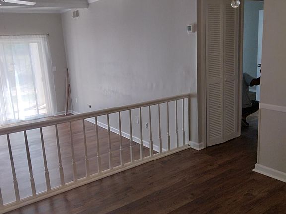 From entry, view of dining area and step down to light-filled 
living room with sliding glass doors to patio. Living room has ceiling fan and cable hook-up.
