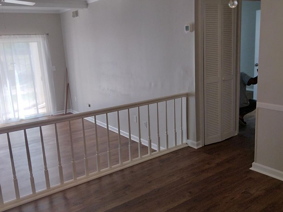 From entry, view of dining area and step down to light-filled 
living room with sliding glass doors to patio. Living room has ceiling fan and cable hook-up.