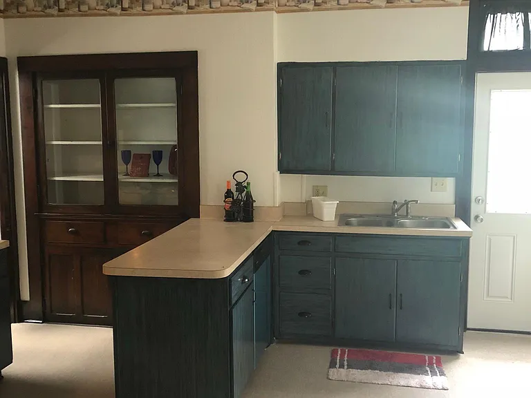 Check out this gorgeous kitchen. Love this color on the cabinet. Extra built in cabinet for your kitchen treasures.