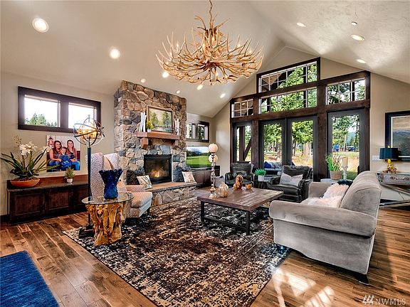 Soaring ceilings, classic northwest chandelier, floor to ceiling stone fireplace and gorgeous wood floors welcome you immediately to this beautiful home.