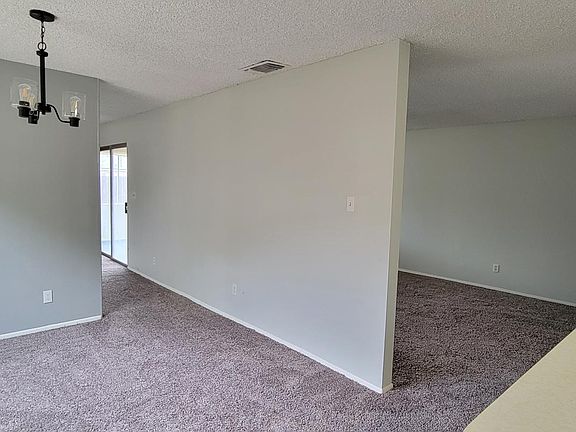 View from kitchen shows dining area and living room