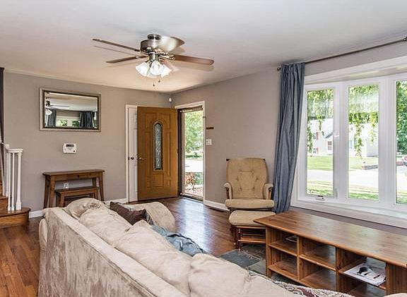 Neutral and bright living room has a bay window