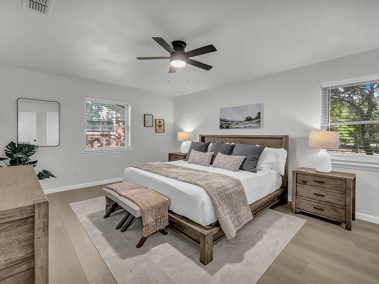 King size bed with window overlooking the lake and backyard activities. Two night stands with drawers and lamps