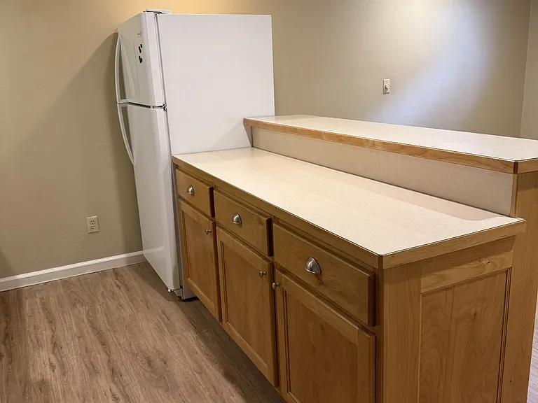 Kitchen. New range and new flooring. Kitchen island eating bar on the back of the cabinetry.