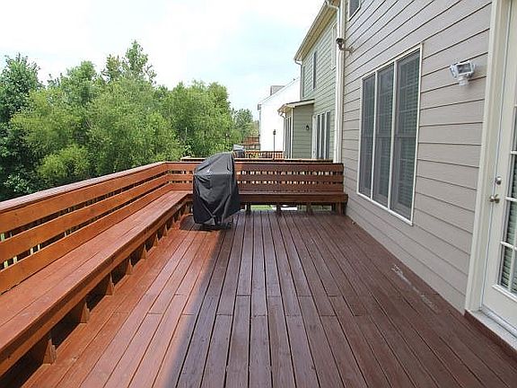 Deck was extended the full width of the home and benches were installed