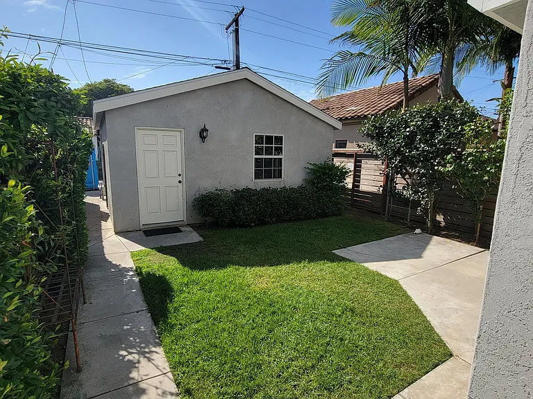 Two car detached garage with additional parking, morning sun exposure.