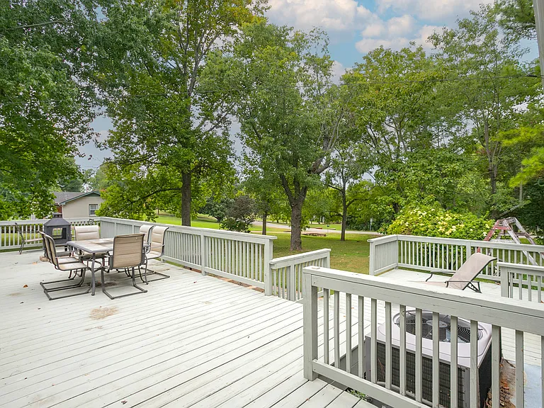 Massive patio out back to oversee the acre lot with beautiful mature trees.