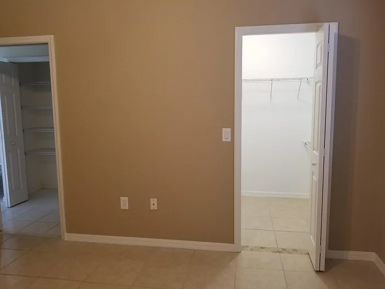 2nd floor bedroom. Doorways to the bath and walk-in closet.