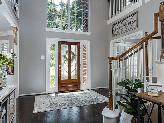 WOW! A gorgeous entryway is beaming with pride from all the natural light that flows from the leaded glass doors, sidelights, and HUGE transom window!