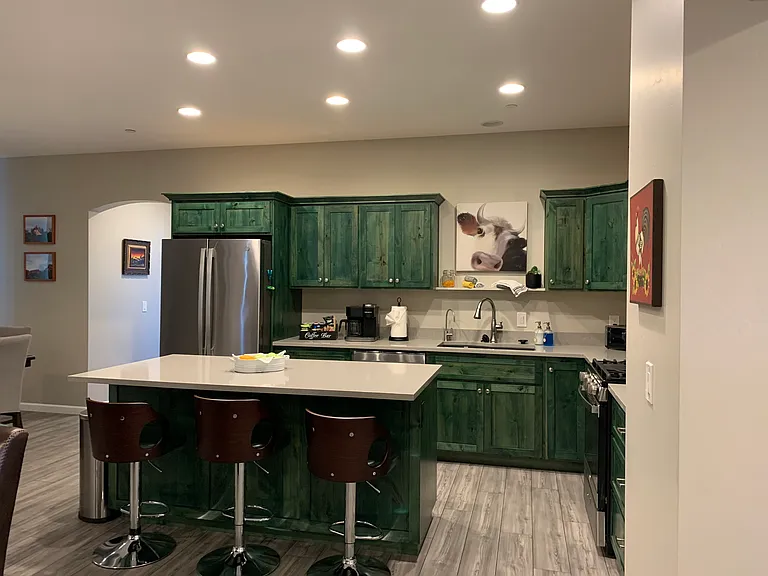 Modern Kitchen with all stainless steel appliances including Side by Side refrigerator with ice maker, natural gas stove, microwave, dishwasher and garbage disposal.