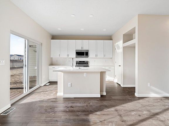 A view of the kitchen, island and patio entry
