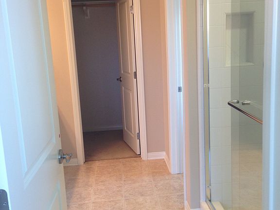 master bathroom with 2 sinks, toilet, shower, and walk in cl