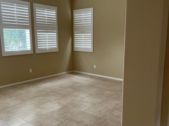 Stone flooring and custom warm tuscanny paint colors throuhout. White custom shutters for the windows.