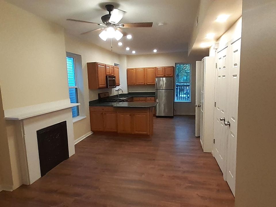 view of living/kitchen area from door of front (master) bedroom