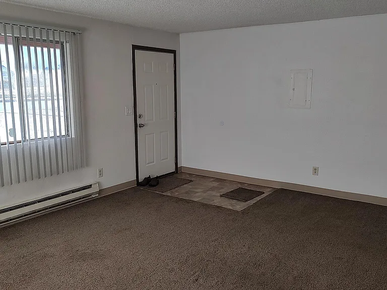 Entry door and light-filled living room area.