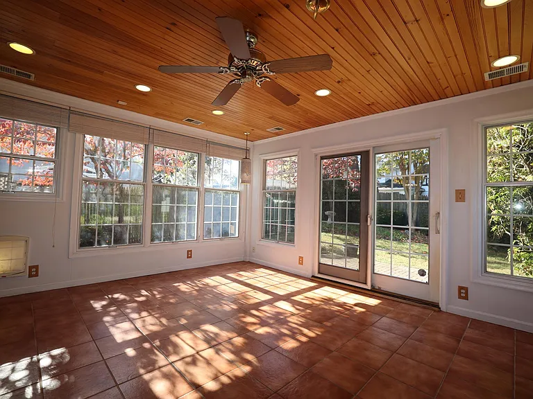 Spacious sun room with windows on all sides.