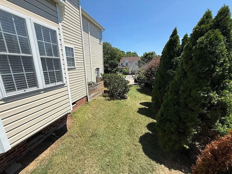 The other side of the yard. Tree lined for privacy between the home and the backyard neighbor.