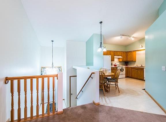 Split entry opens into a foyer that includes a convenient coat closet.  Stylish railing allows open viewing into dining/living room areas.